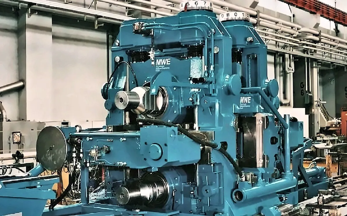 Rolling mill stand bearing the MWE nameplate, in the workshop